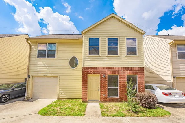 a view of a brick house with many windows