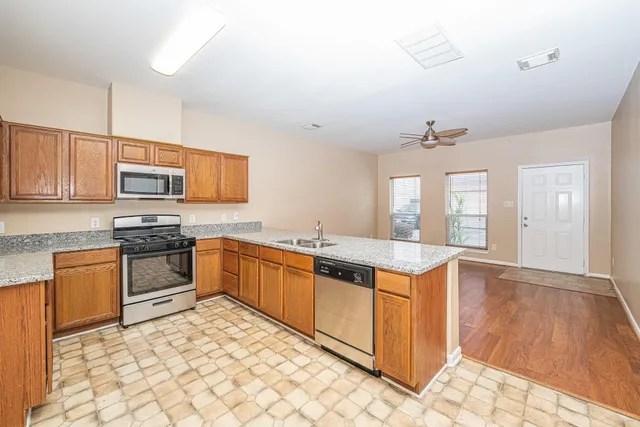 a kitchen with stainless steel appliances granite countertop a stove and a sink