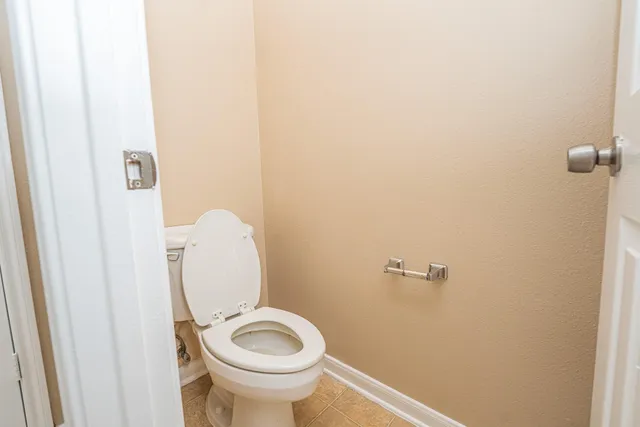 a bathroom with a toilet and a mirror