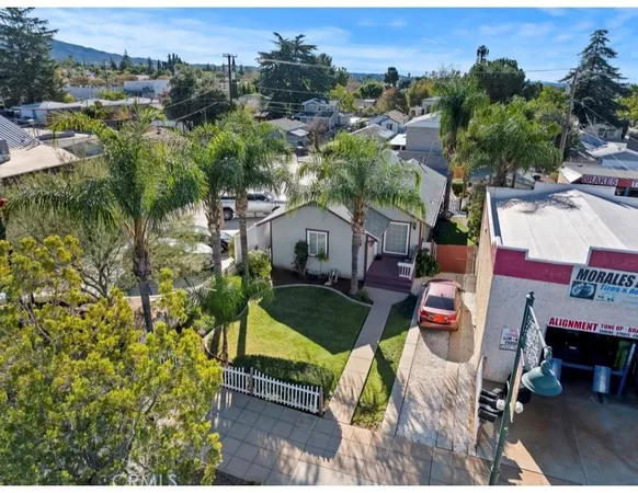 an aerial view of a house with outdoor space patio and outdoor seating