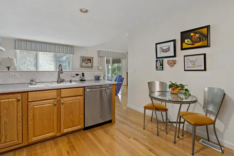 a kitchen with stainless steel appliances granite countertop a sink and a refrigerator