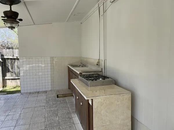 a stove top oven sitting inside of a kitchen