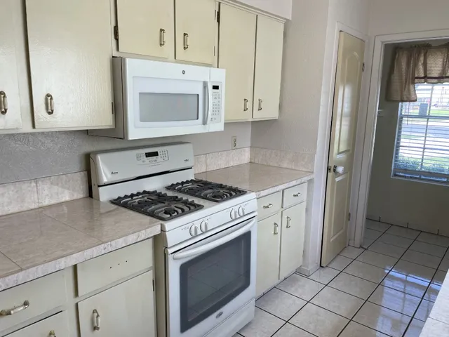 a kitchen with cabinets and appliances