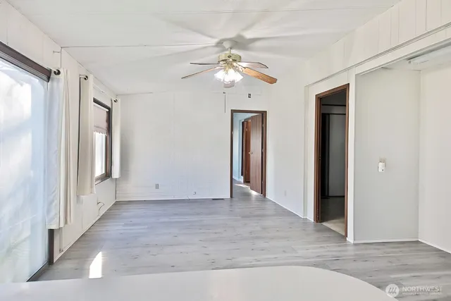 an empty room with fan and entrance