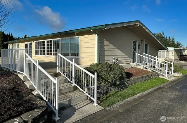 a view of a house with wooden fence