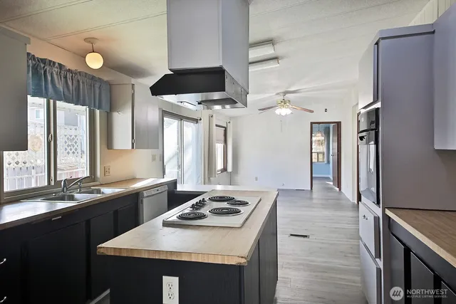 a kitchen with a sink stove and refrigerator