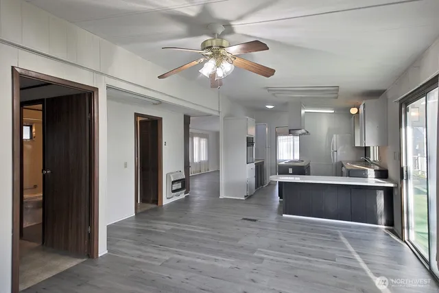 a view of kitchen with sink and refrigerator