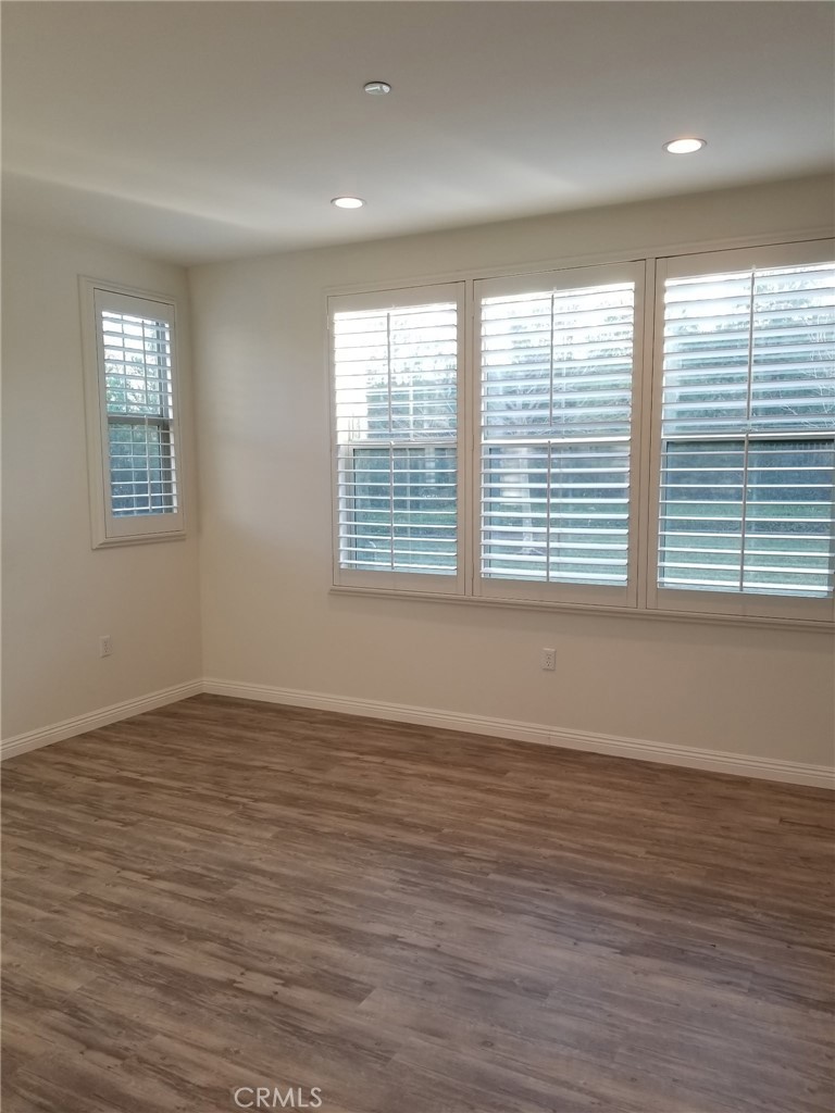 74 Rose Arch Irvine, CA 92620 - Photo 11 of 21 a view of an empty room with wooden floor and a window