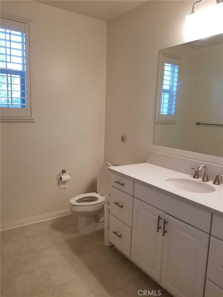 74 Rose Arch Irvine, CA 92620 - Photo 18 of 21 a bathroom with a toilet sink and mirror