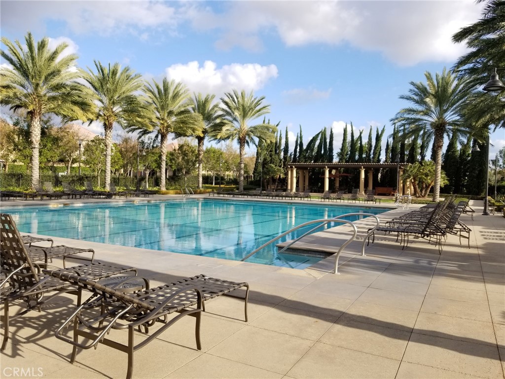 74 Rose Arch Irvine, CA 92620 - Photo 20 of 21 a view of swimming pool with a table and chairs