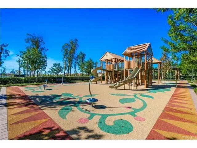 a view of a swimming pool with lawn chairs under an umbrella