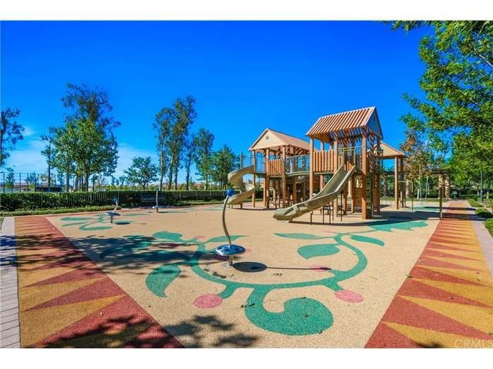 74 Rose Arch Irvine, CA 92620 - Photo 3 of 21 a view of a swimming pool with lawn chairs under an umbrella