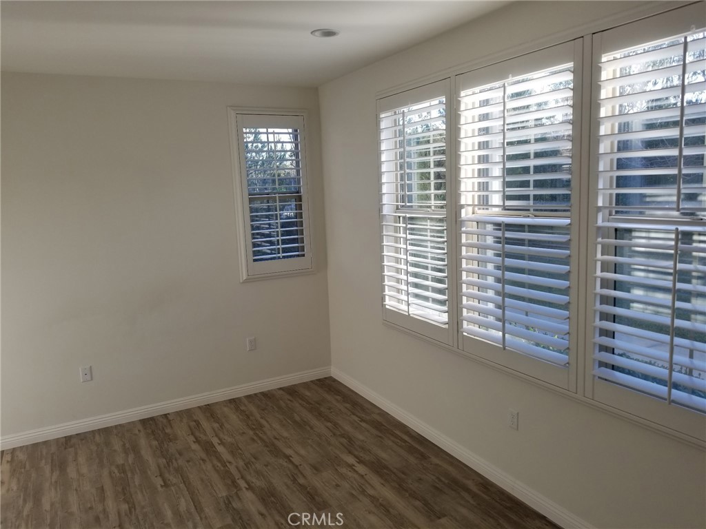 74 Rose Arch Irvine, CA 92620 - Photo 10 of 21 a view of an empty room with wooden floor and a window