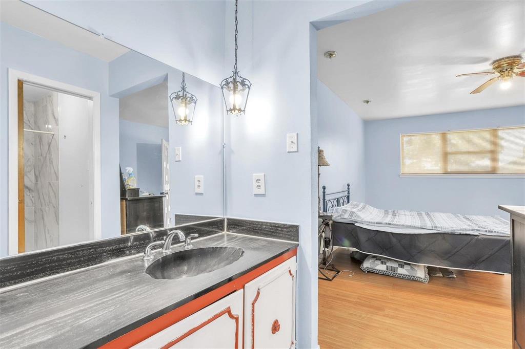 3226 Barnes Bridge Road Dallas, TX 75228 - Photo 14 of 27 a bathroom with a sink double vanity and a mirror