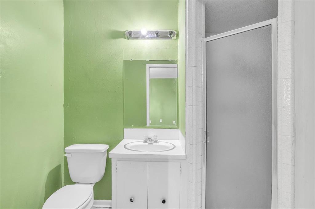 3226 Barnes Bridge Road Dallas, TX 75228 - Photo 16 of 27 a bathroom with a toilet and a sink