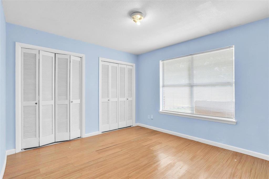 3226 Barnes Bridge Road Dallas, TX 75228 - Photo 19 of 27 an empty room with wooden floor and windows
