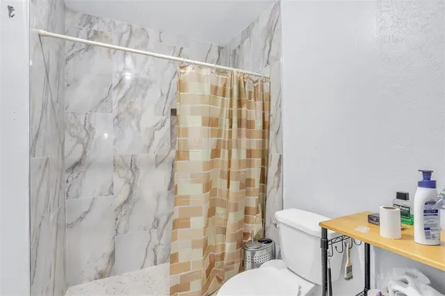 a white toilet sitting next to a bathroom sink