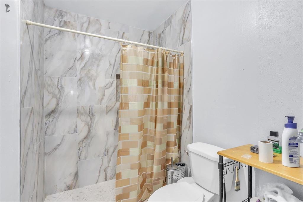 3226 Barnes Bridge Road Dallas, TX 75228 - Photo 26 of 27 a white toilet sitting next to a bathroom sink