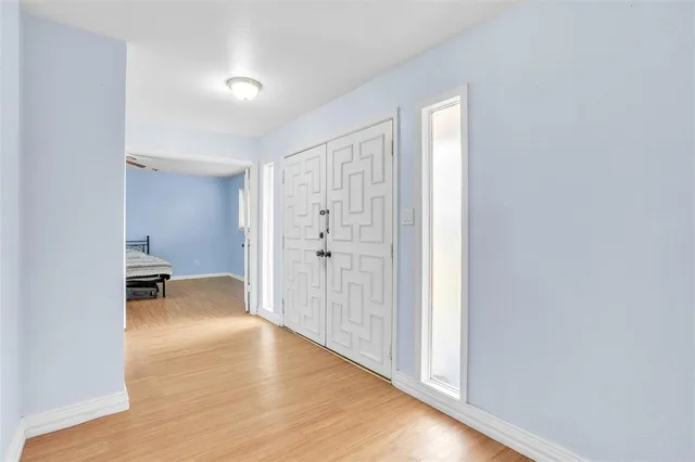 a view of empty room with wooden floor