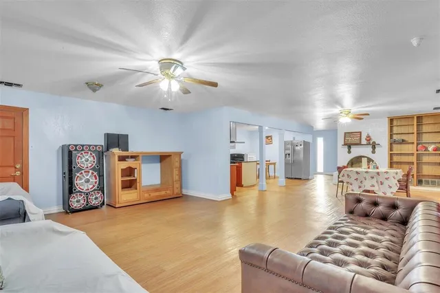 a living room with furniture and kitchen view