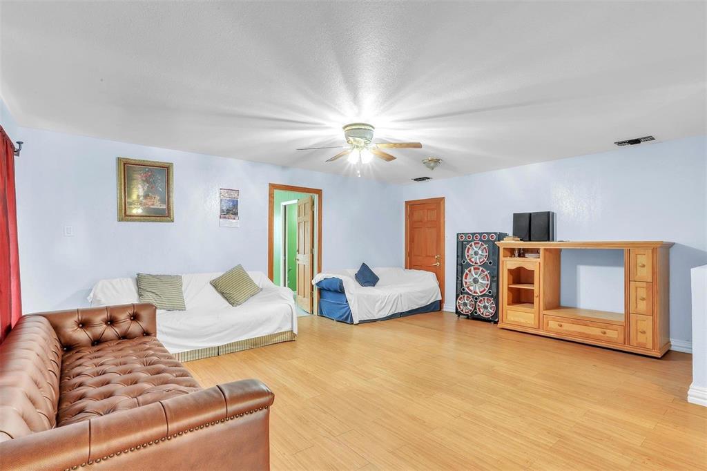 3226 Barnes Bridge Road Dallas, TX 75228 - Photo 6 of 27 a living room with furniture and a chandelier