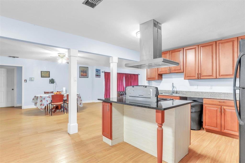 3226 Barnes Bridge Road Dallas, TX 75228 - Photo 10 of 27 a kitchen that has a lot of cabinets in it and wooden floor