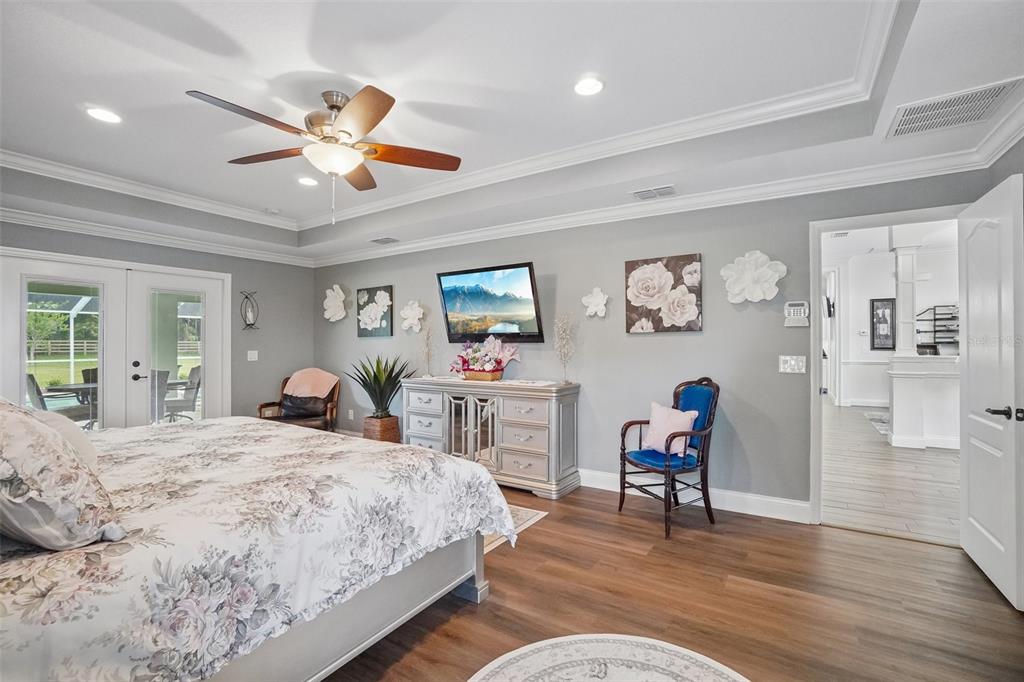 3934 Connersville Road Bartow, FL 33830 - Photo 27 of 81 a bedroom with a bed and a chandelier