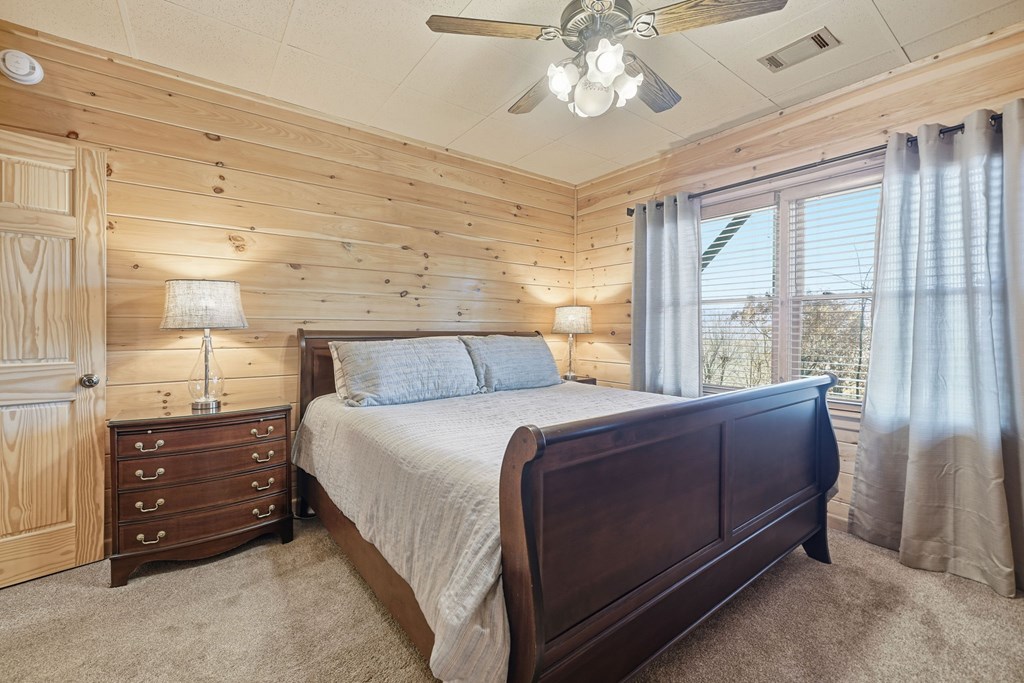 478 Cohutta Mountain Road Blue Ridge, GA 30513 - Photo 18 of 47 a bed sitting in a spacious bedroom next to a window