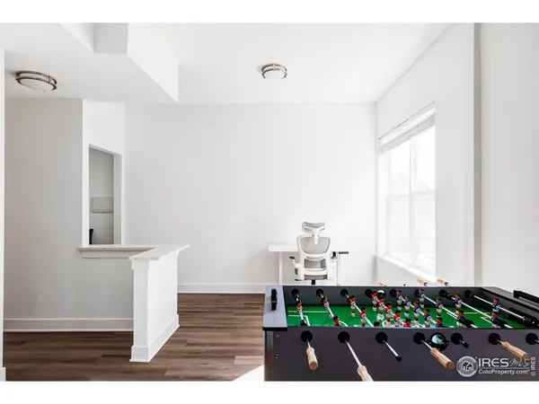 a living room with furniture and a painting on the wall