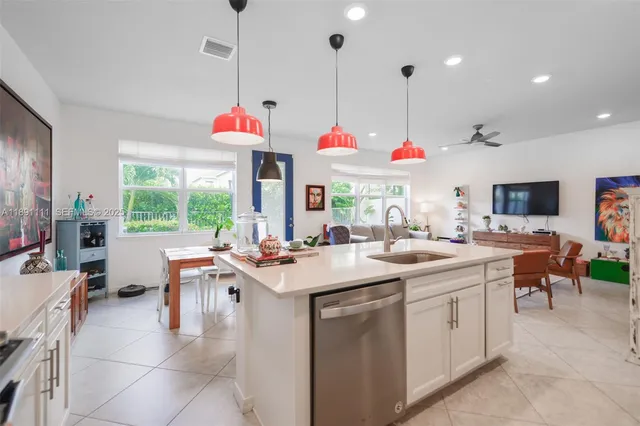a kitchen with a sink stove and white cabinets