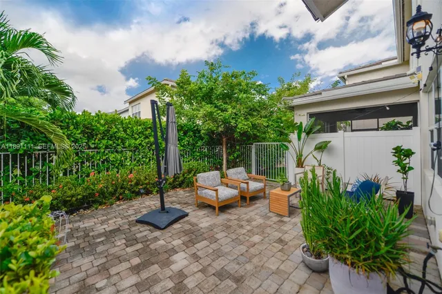 a backyard of a house with table and chairs