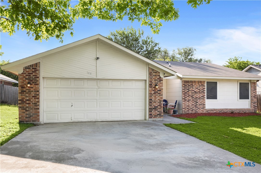 144 Jordan Loop Nolanville, TX 76559 - Photo 1 of 20 a front view of a house with a yard and garage