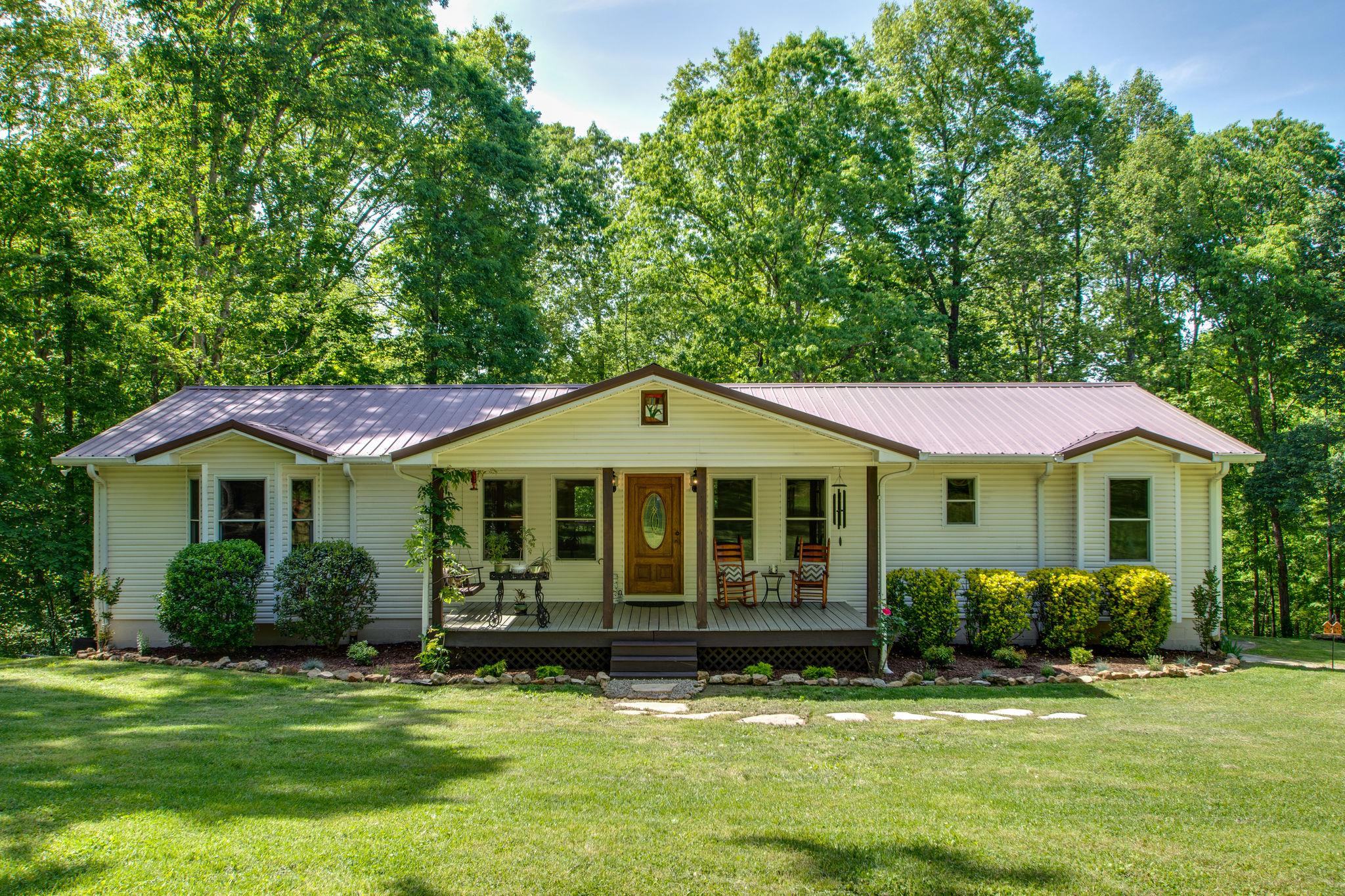 1017 Deer Ridge Road Kingston Springs, TN 37082 - Photo 1 of 29 a front view of a house with a garden