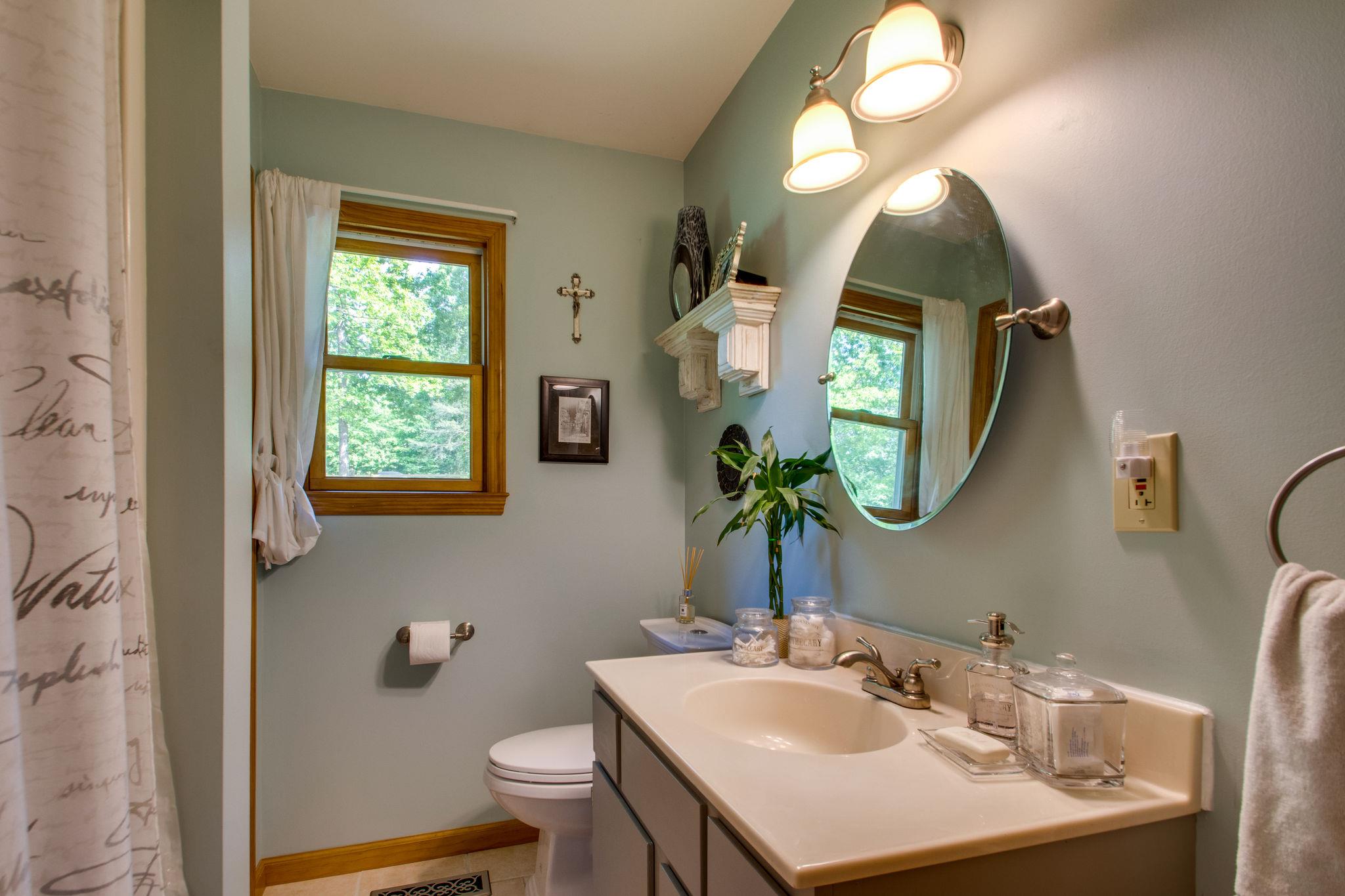 1017 Deer Ridge Road Kingston Springs, TN 37082 - Photo 20 of 29 a bathroom with a sink a toilet and a mirror