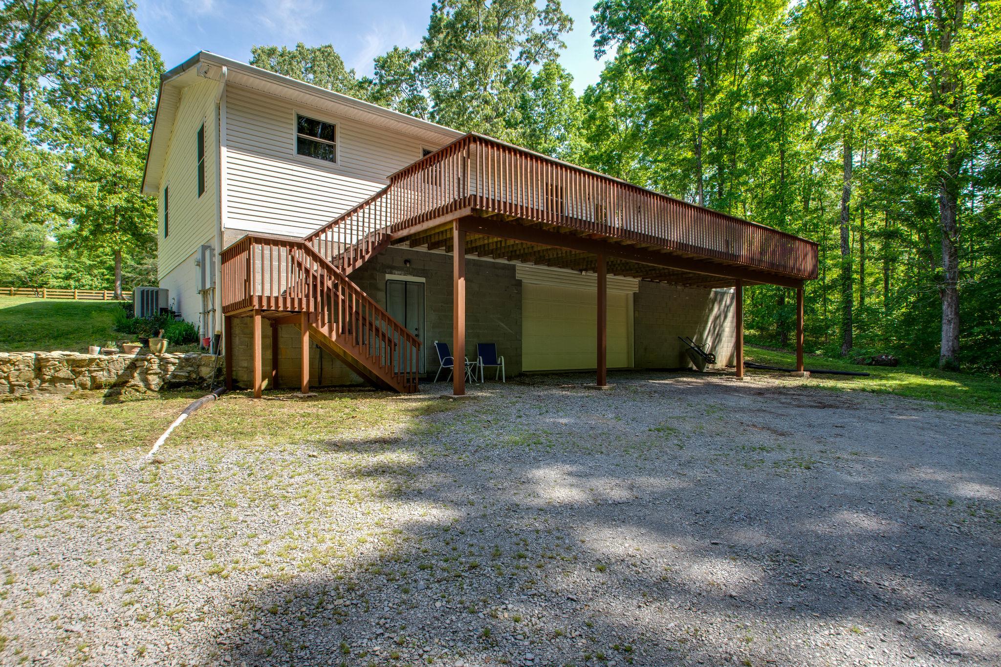 1017 Deer Ridge Road Kingston Springs, TN 37082 - Photo 25 of 29 a view of a house with backyard and trees