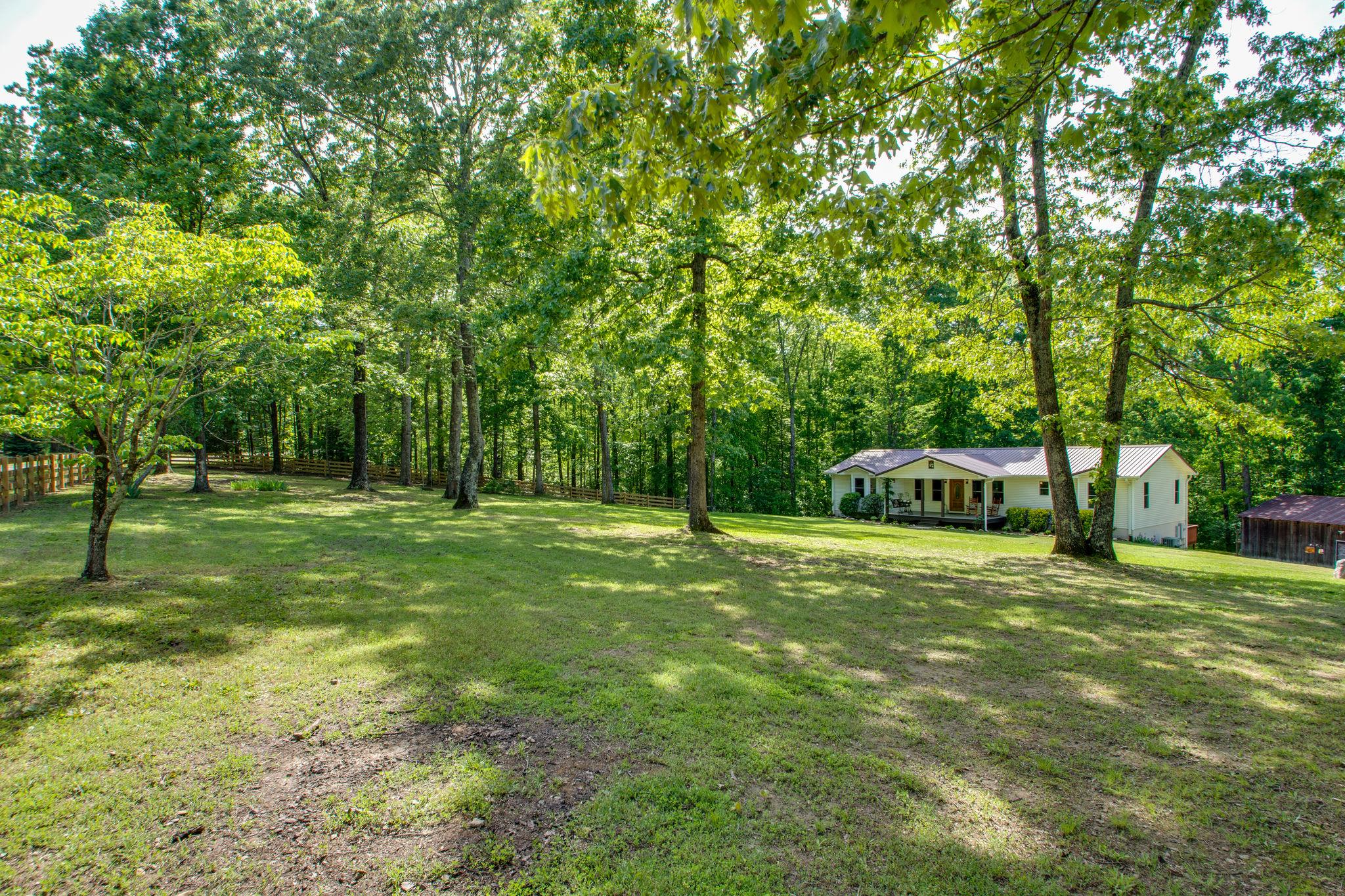 1017 Deer Ridge Road Kingston Springs, TN 37082 - Photo 3 of 29 a backyard of a house with trees and plants