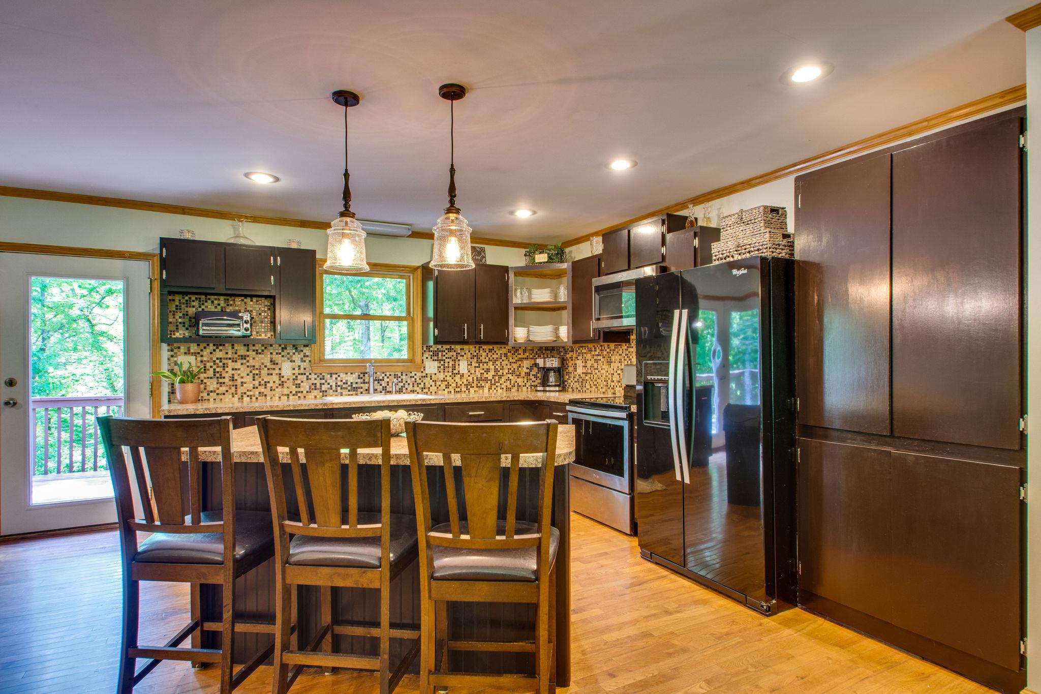 1017 Deer Ridge Road Kingston Springs, TN 37082 - Photo 10 of 29 a kitchen with a table and chairs