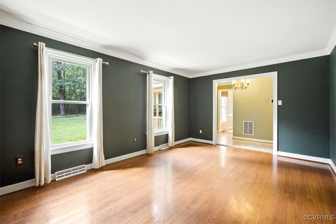 13241 Bailey Bridge Road Midlothian, VA 23112 - Photo 7 of 50 an empty room with wooden floor and windows