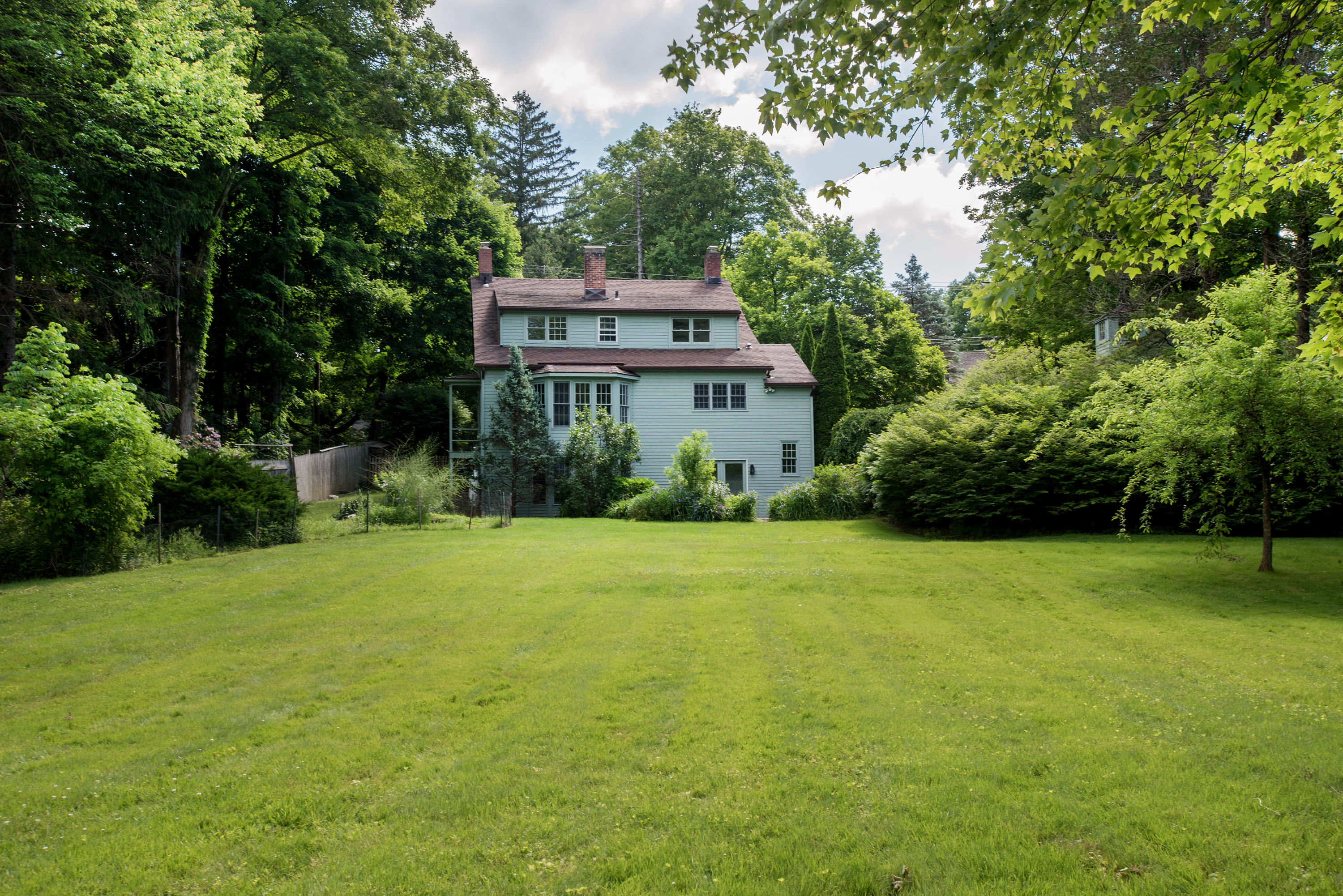 2884 Long Ridge Road Stamford, CT 06903 - Photo 4 of 20 a front view of a house with a garden