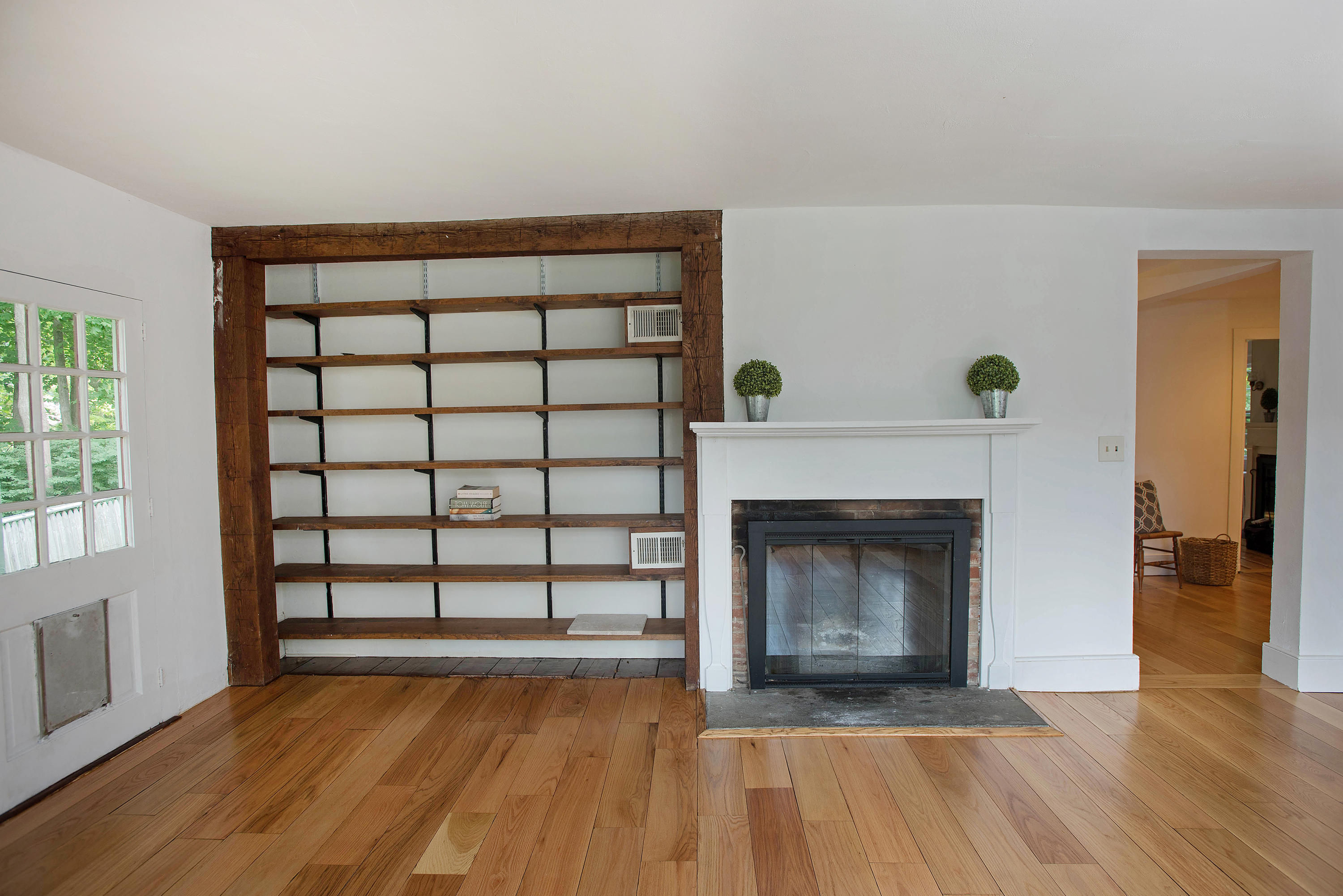 2884 Long Ridge Road Stamford, CT 06903 - Photo 10 of 20 a view of an empty room with wooden floor fireplace and a window