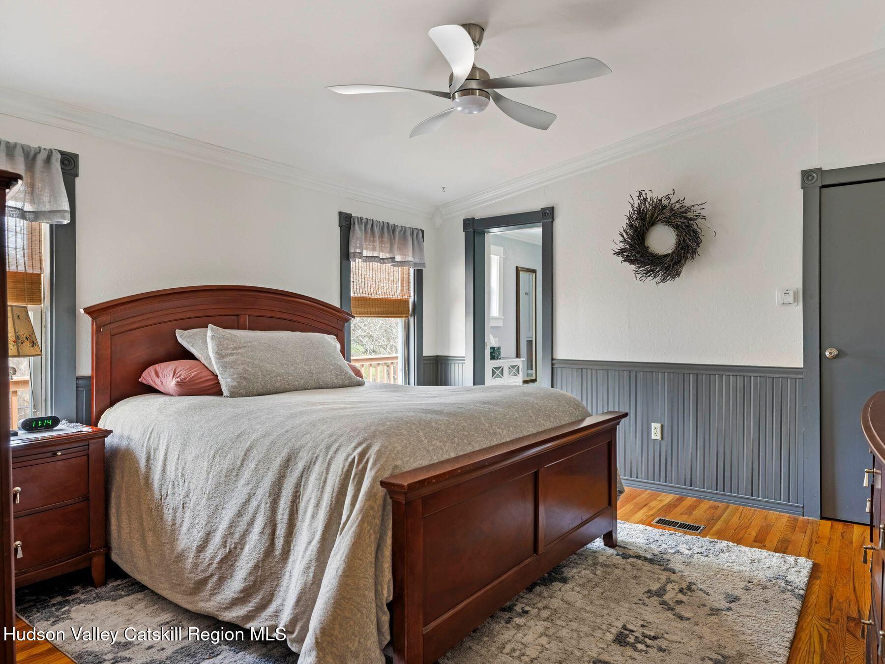 382 Cairo Junction Road Catskill, NY 12414 - Photo 23 of 38 a bedroom with a bed and a chandelier