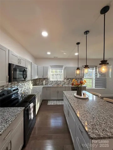 a kitchen with sink stove and cabinets