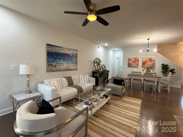 a living room with furniture and a chandelier