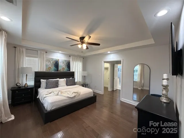 a bedroom with a bed a mirror and furniture