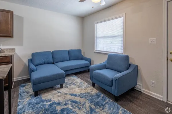 a living room with furniture a couch and a window