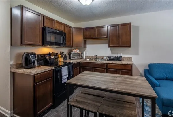 a kitchen with a stove a sink and a refrigerator