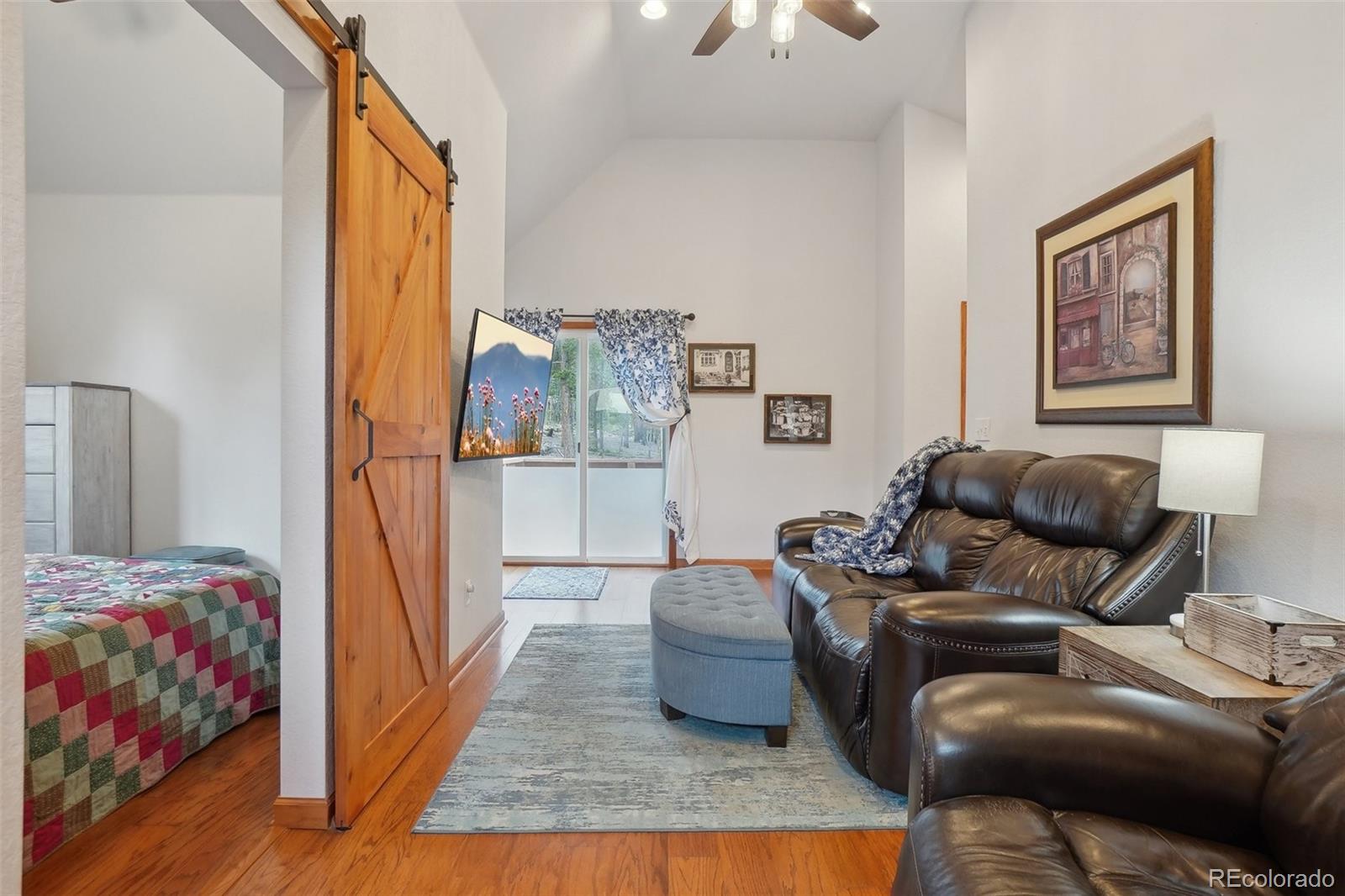 125 Aspen Road Black Hawk, CO 80422 - Photo 36 of 44 a living room with furniture and a floor to ceiling window