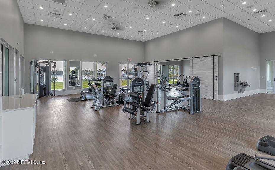 384 Rum Runner Way St. Johns, FL 32259 - Photo 15 of 21 a view of a room with gym equipment and a large window