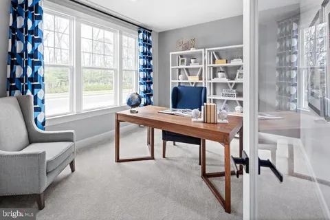 a workspace with furniture and a window