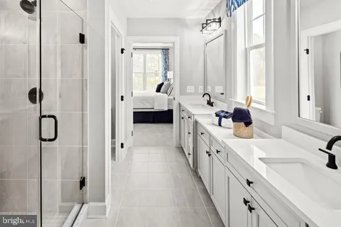 a large white bathroom with a granite countertop sink mirror and a bathtub